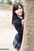 Kasugano Yui standing behind tree wearing uniform