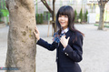 Student standing under tree