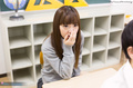 Nishino ena seated with hand raised to her mouth