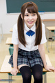 Atomi shuri sitting on desk wearing uniform hair in pigtails wearing stockings