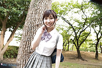 Student standing under tree