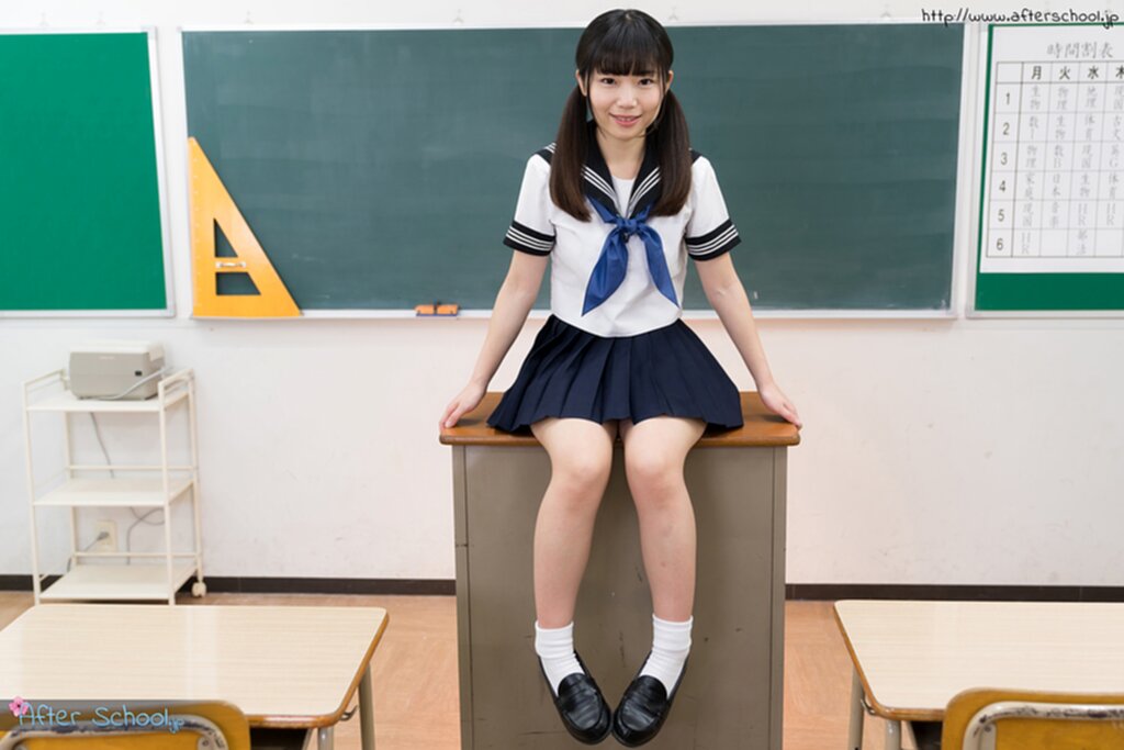 Seated in classroom wearing uniform hair in pigtails