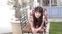 Reina on all fours on garden bench long hair wearing brown dress