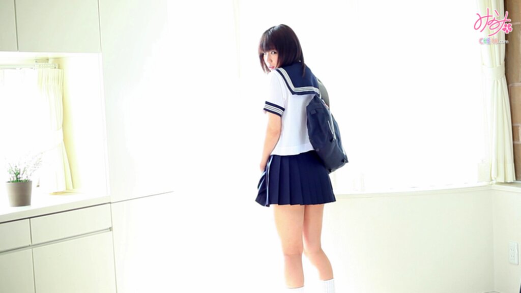 Standing against window looking over her shoulder wearing sailor suit uniform bag over her shoulder