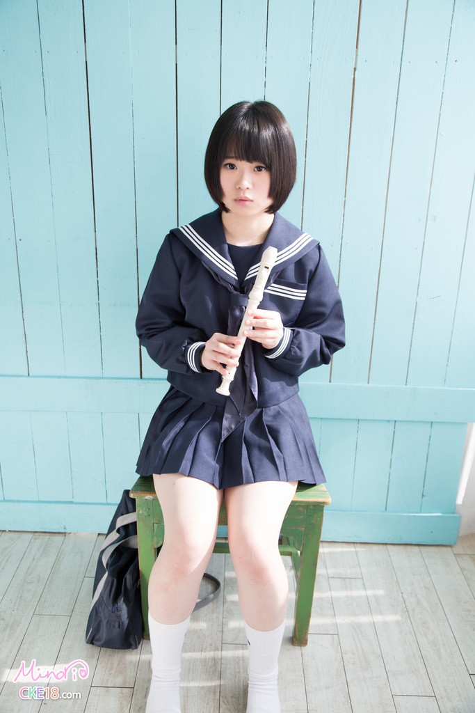 Kogal seated on chair wearing uniform holding recorder