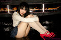 Mizushima ai seated with knees drawn up wearing short skirt in high heels