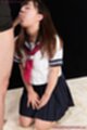 On her knees sucking cock head wearing uniform