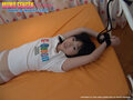 Tied by her hands to a bed wearing tshirt and panties.jpg