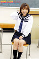 Japanese teen norika makihara seated on chair in classroom wearing kogal uniform hand resting on her lap.jpg