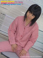 Japanese teen ran amami seated in front of blinds wearing check pyjamas hand resting between her legs.jpg