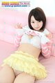 Lying back on couch short hair raising top over her bra frilly yellow skirt raised over her shaved pussy cleft.jpg