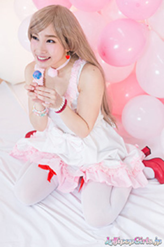 Kasugano yui kneeling holding lollipop wearing stockings in high heels
