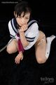 Kogal on her knees in uniform looking up wearing bondage chain