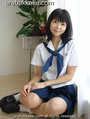 Seated on wood floor wearing kogal uniform hands clasped on her thigh